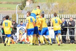 Players mob Max Craggs after his goal against Cleator Moor.