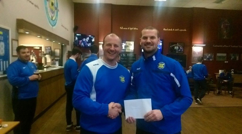 Chris receiving his Player of the Month Award from Manager Michael Dunwell.