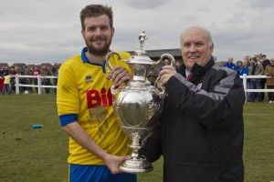 Club Captain Stav Roberts receiving the Shipowners Cup last season from League Chairman Mr Peter Maguire.